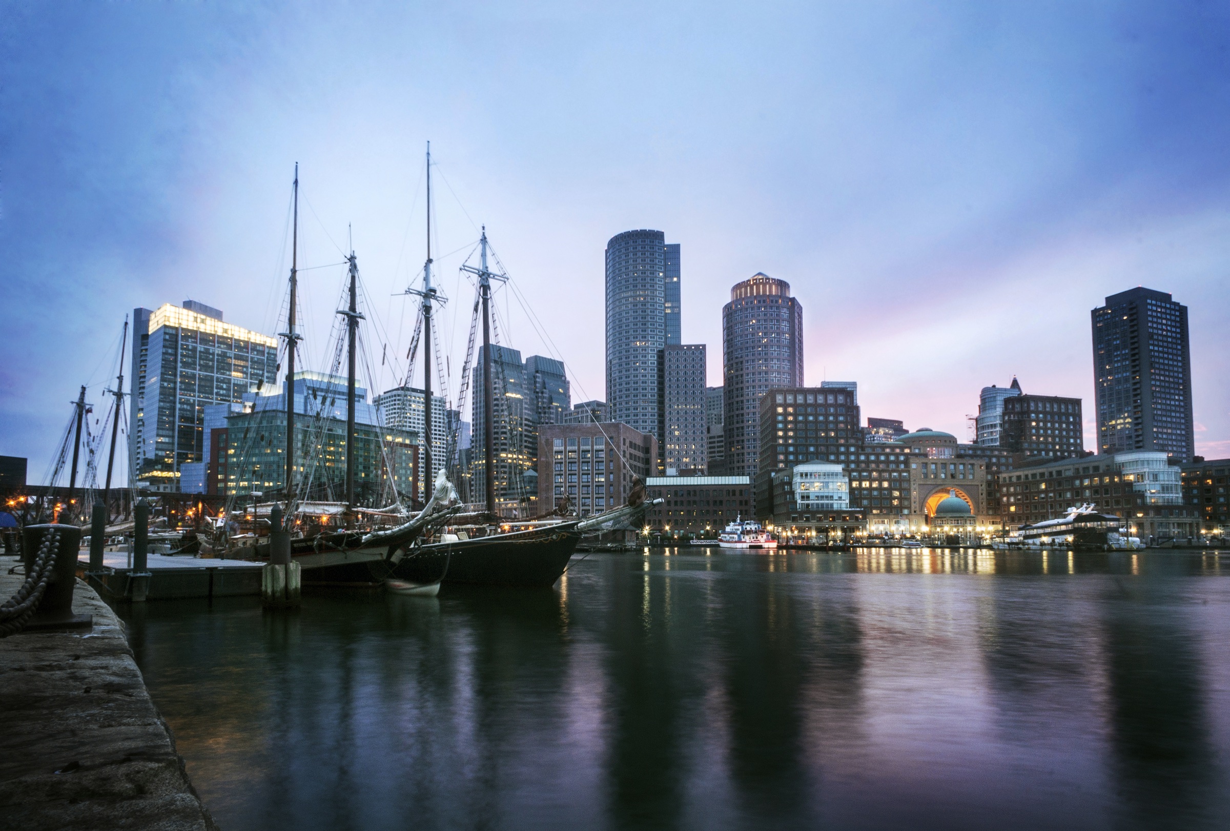 Sailboats and the Boston Waterfront skyline at dusk, viewed from Fan Pier